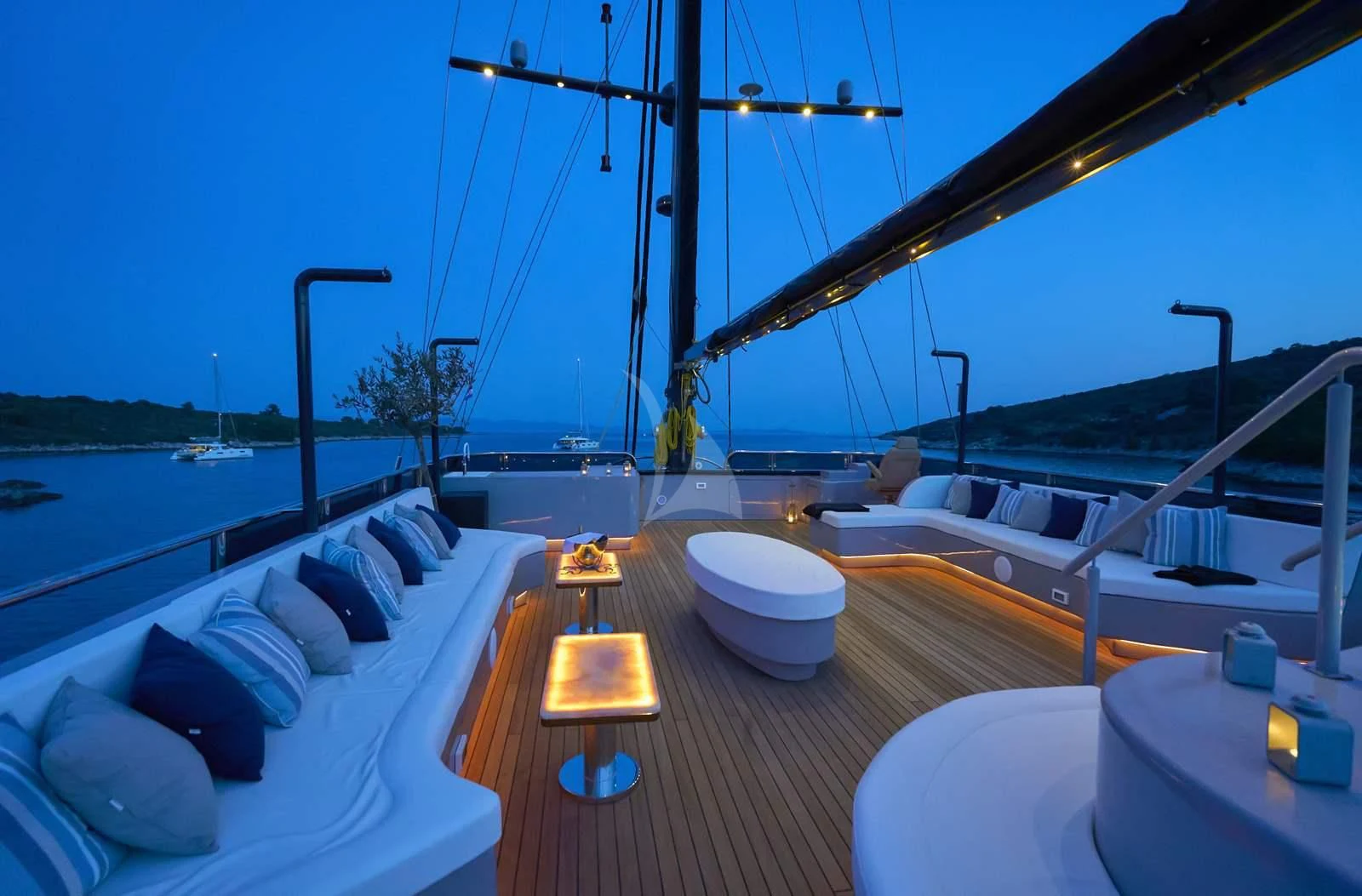a deck with a large bed and a large body of water aboard RARA AVIS Yacht for Charter