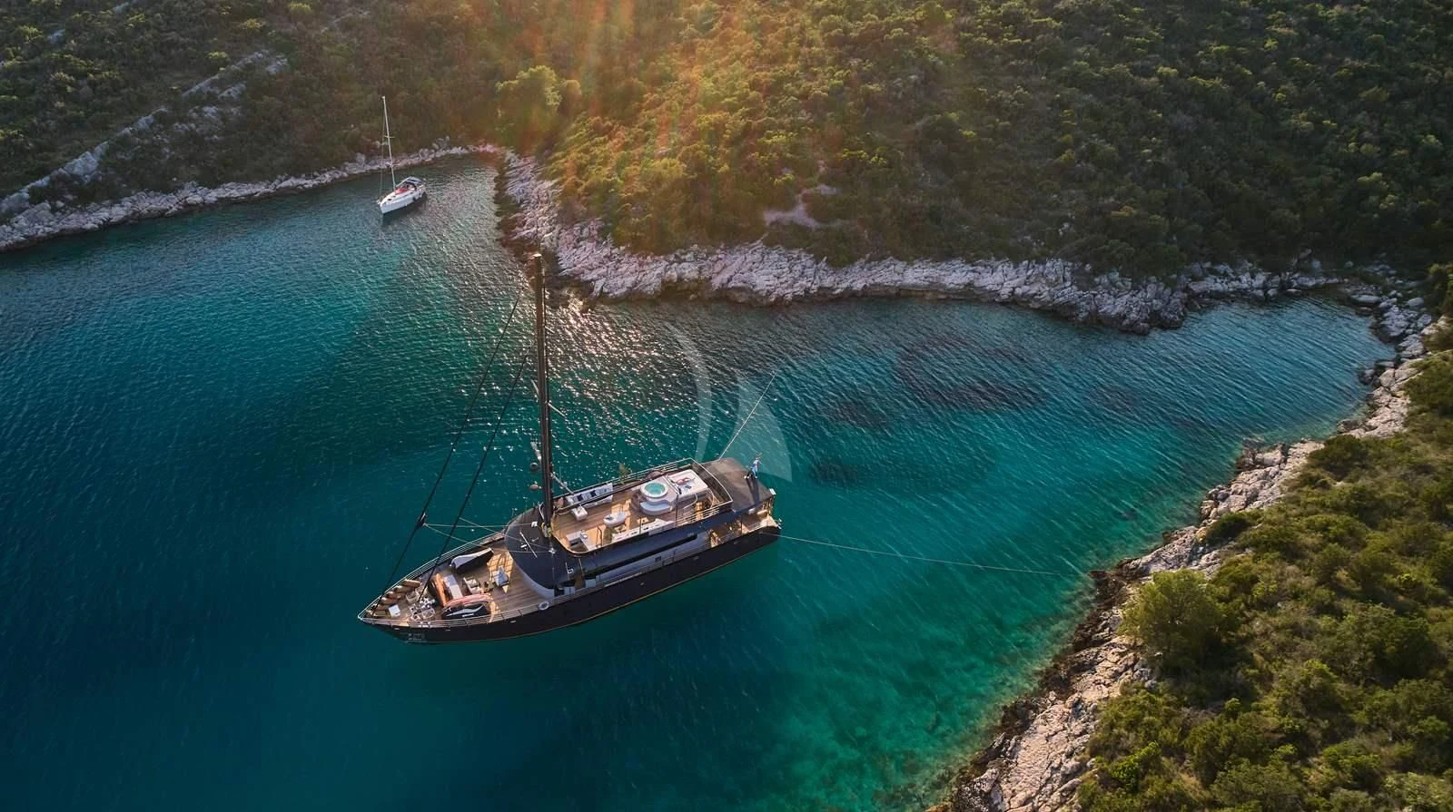 a boat sailing on the water aboard RARA AVIS Yacht for Charter