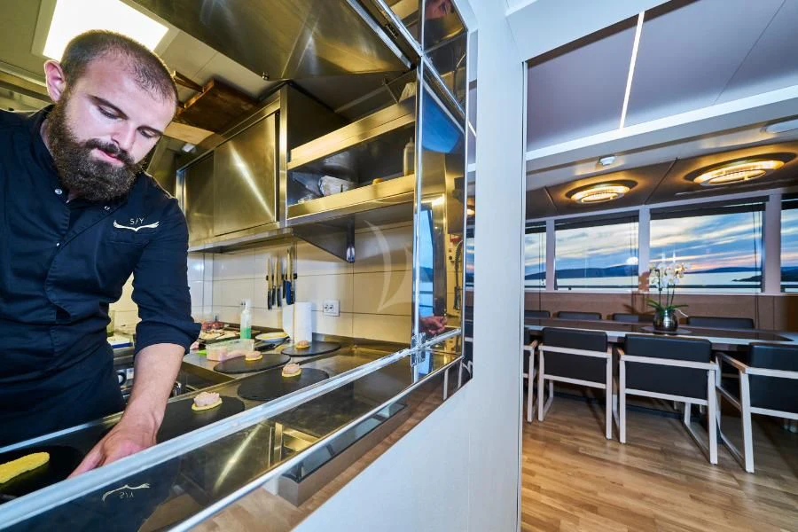a man in a kitchen aboard RARA AVIS Yacht for Charter