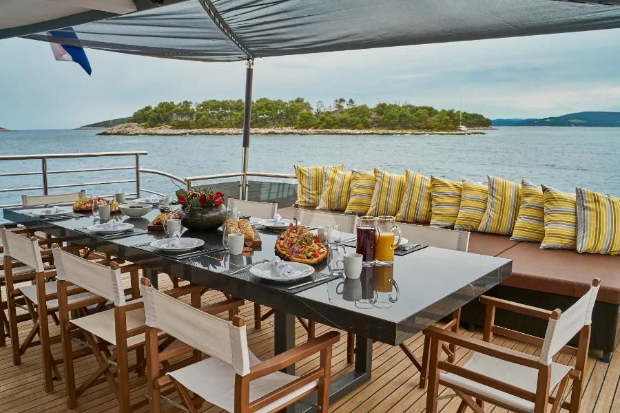 a table set for a meal on a boat aboard RARA AVIS Yacht for Charter