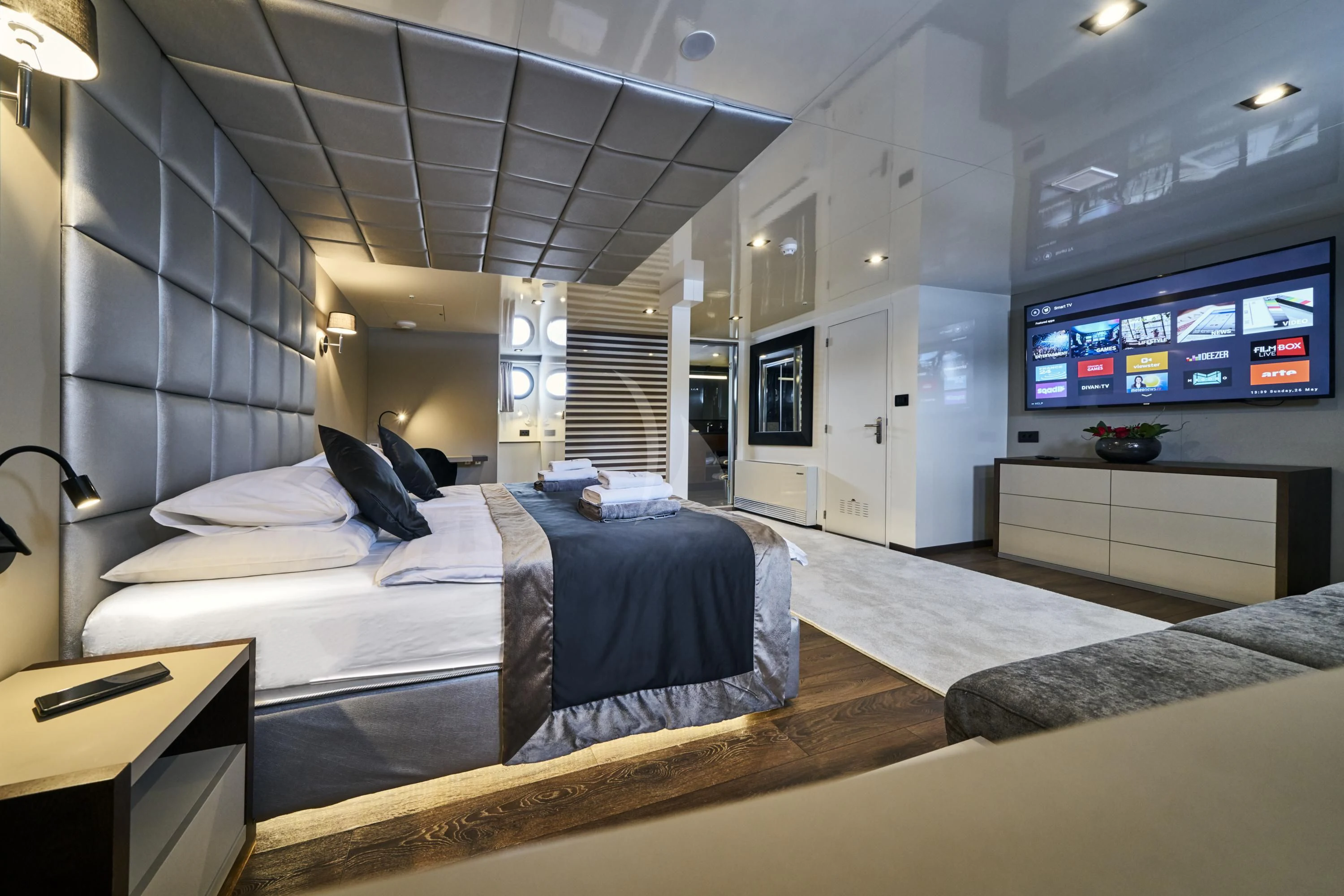 a bedroom with a bed and a tv aboard RARA AVIS Yacht for Charter