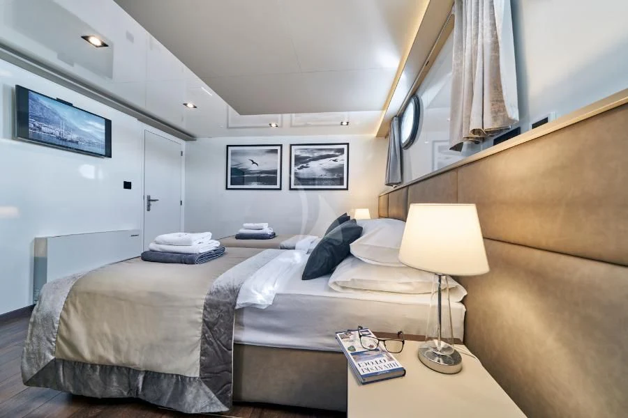 a couple of beds in a hotel room aboard RARA AVIS Yacht for Charter