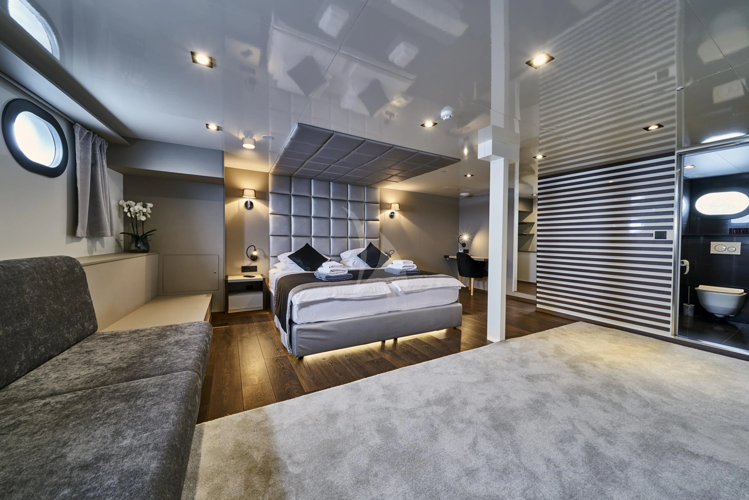a room with a bed and a couch aboard RARA AVIS Yacht for Charter
