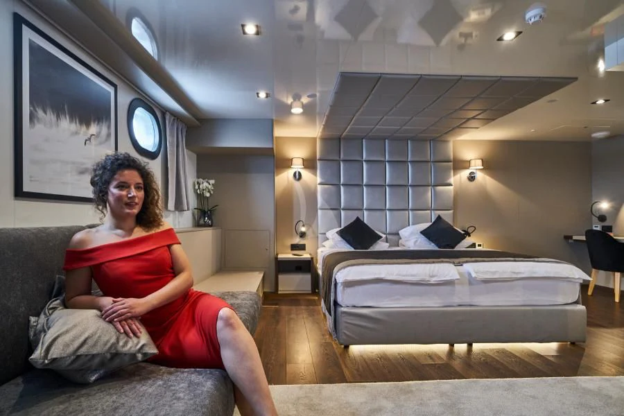 a person sitting on a couch aboard RARA AVIS Yacht for Charter