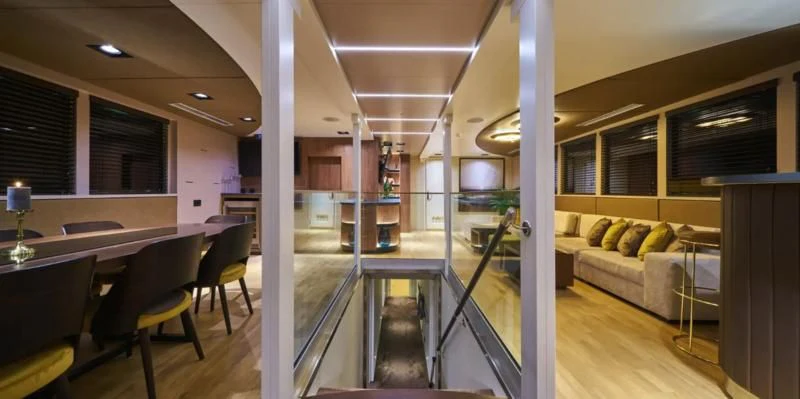 a room with a table and chairs aboard RARA AVIS Yacht for Charter