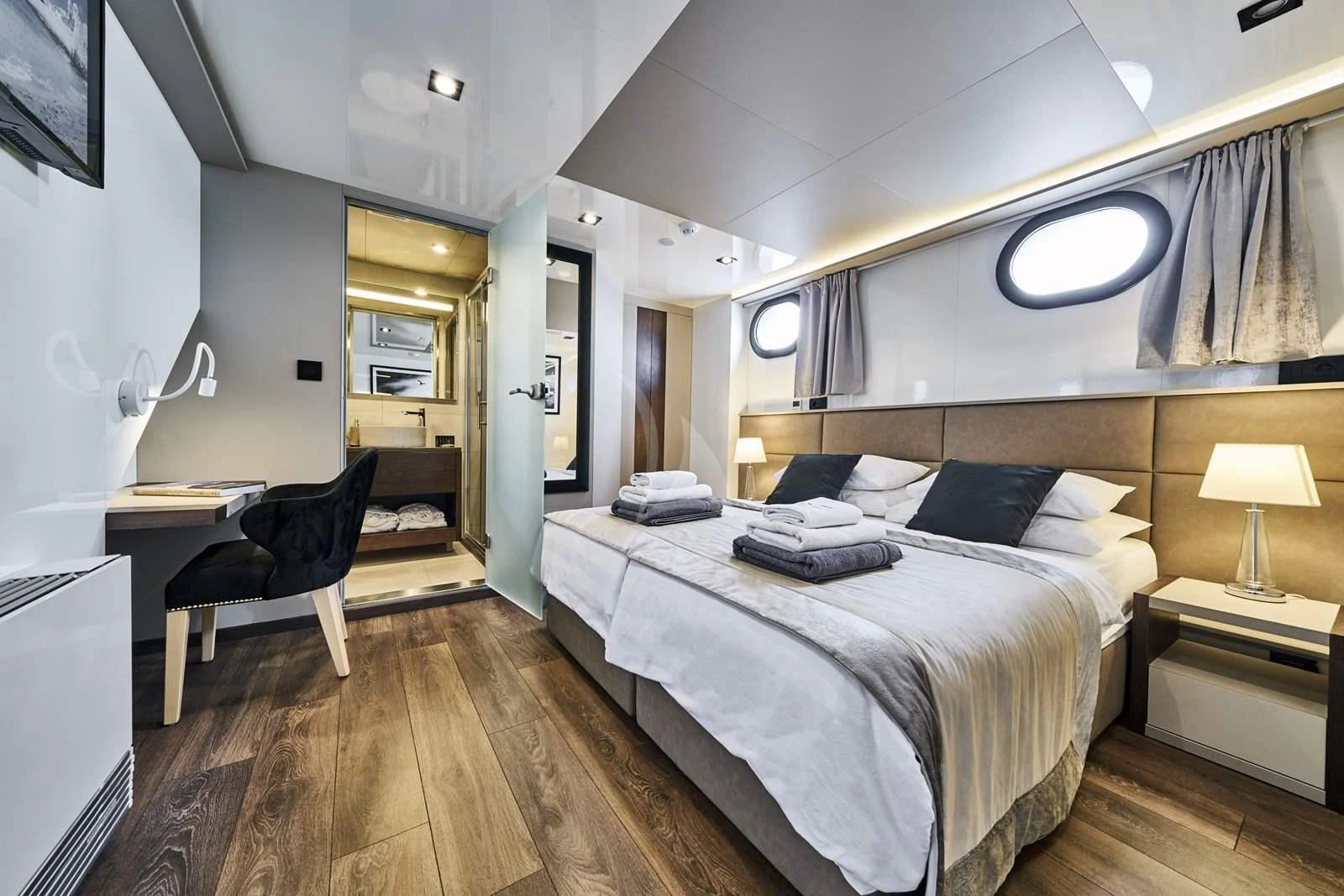 a bedroom with a bed and a chair aboard RARA AVIS Yacht for Charter