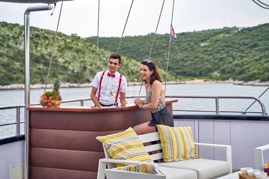 a man and woman sitting on a boat aboard RARA AVIS Yacht for Charter