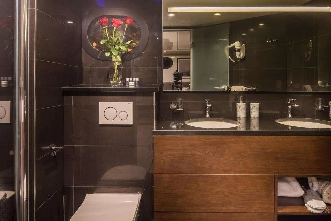 a bathroom with a sink and a mirror aboard RARA AVIS Yacht for Charter