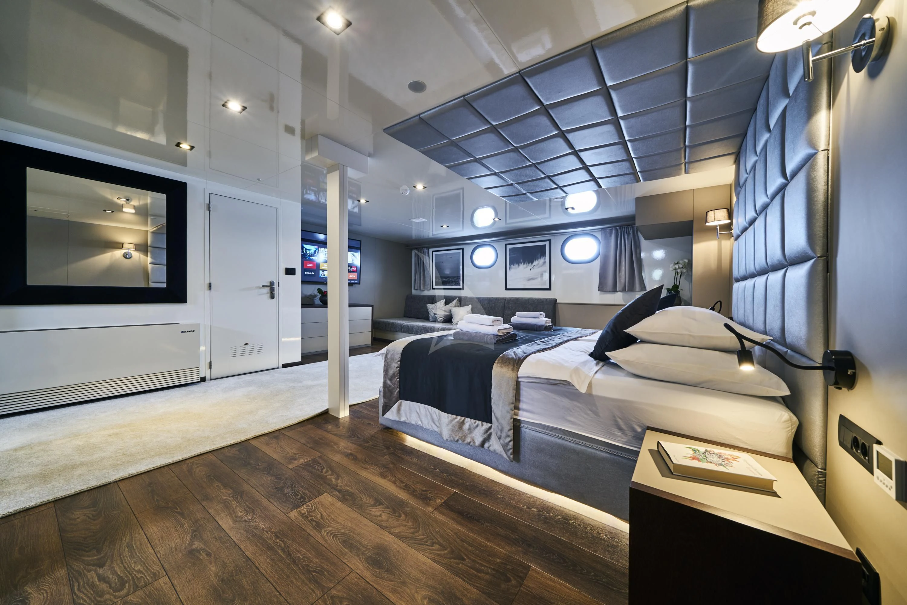 a room with a bed and a tv aboard RARA AVIS Yacht for Charter