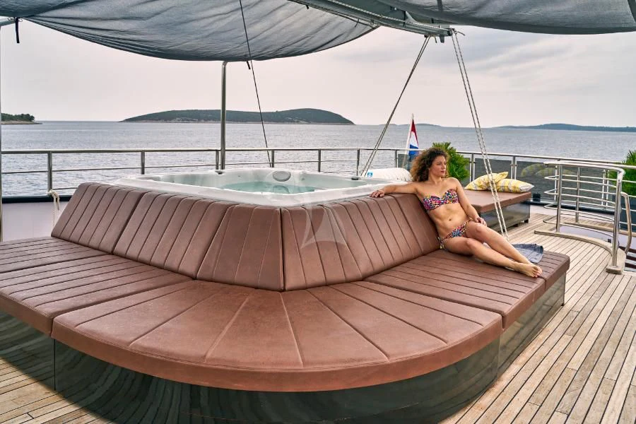 a person sitting on a boat aboard RARA AVIS Yacht for Charter