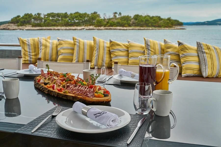 a table with food and drinks on it aboard RARA AVIS Yacht for Charter