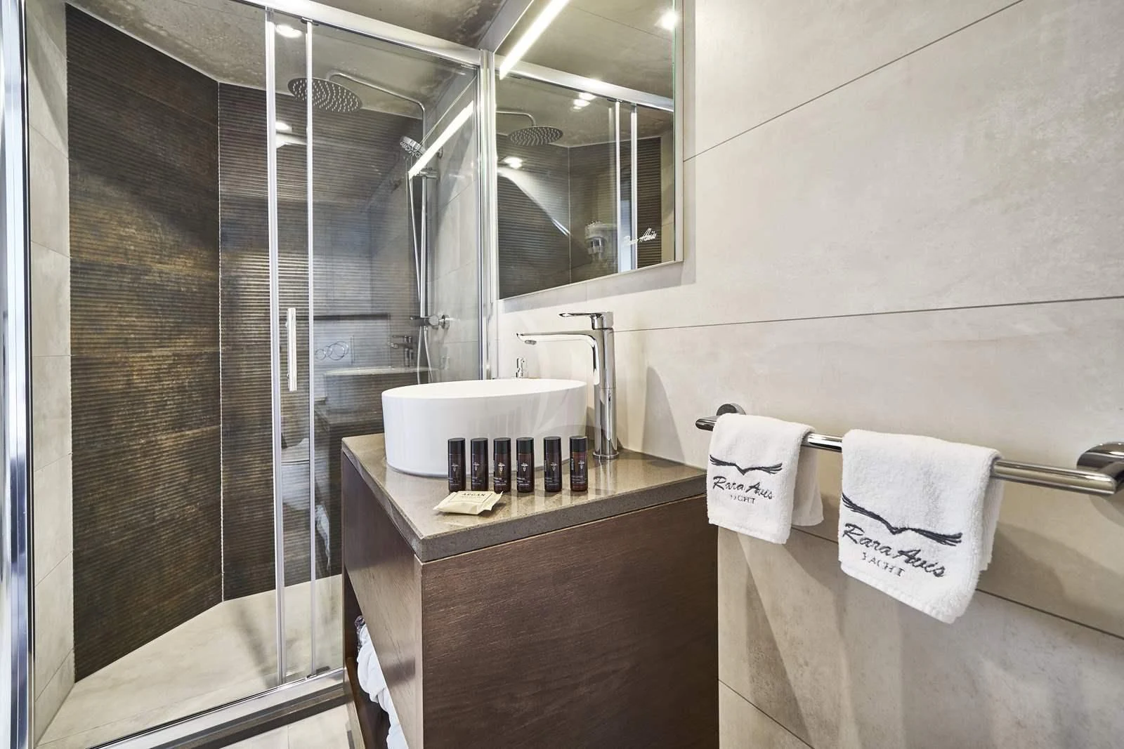 a bathroom with a glass shower aboard RARA AVIS Yacht for Charter