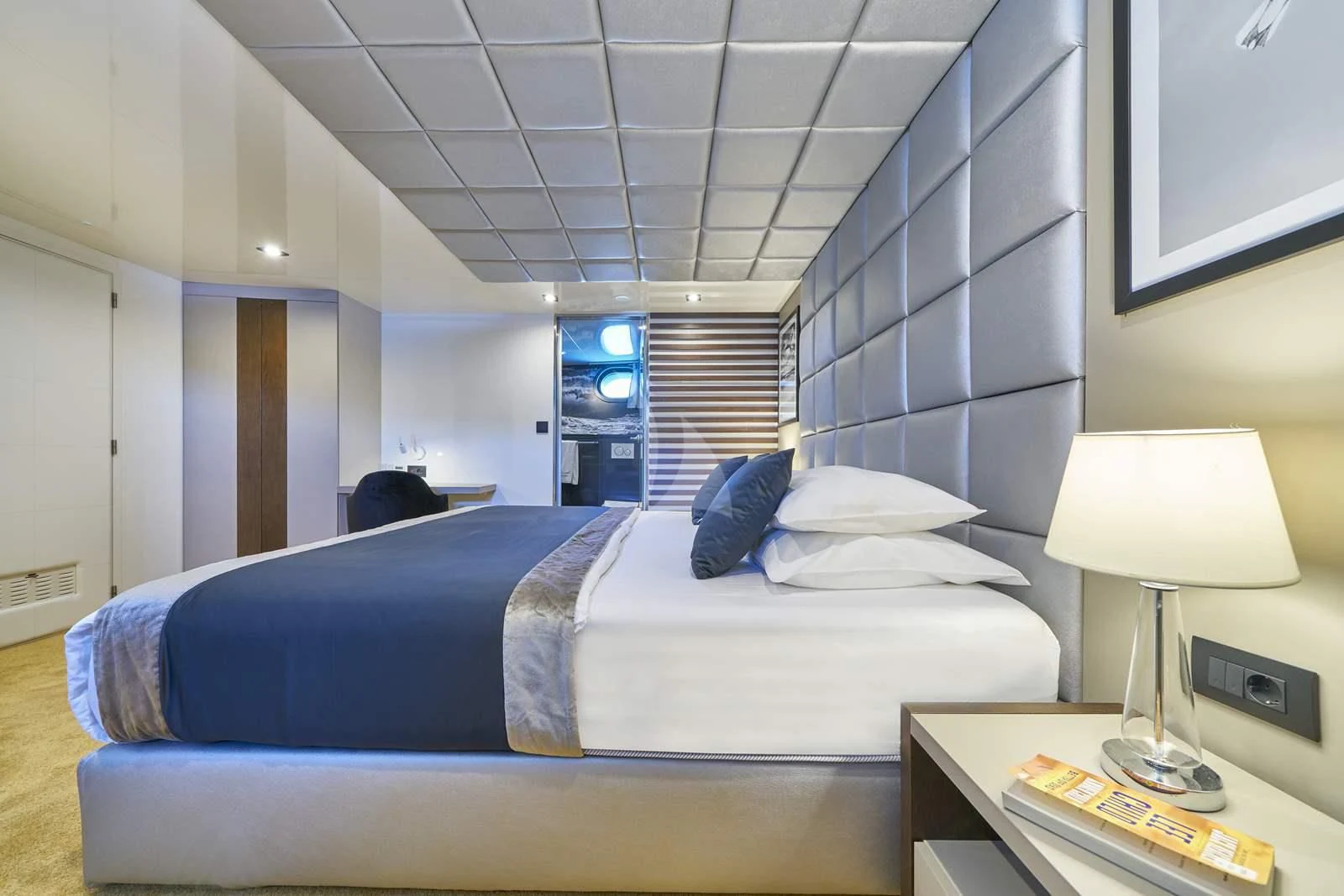 a person sitting on a bed aboard RARA AVIS Yacht for Charter