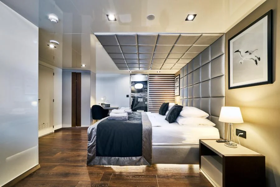 a bedroom with a large bed aboard RARA AVIS Yacht for Charter