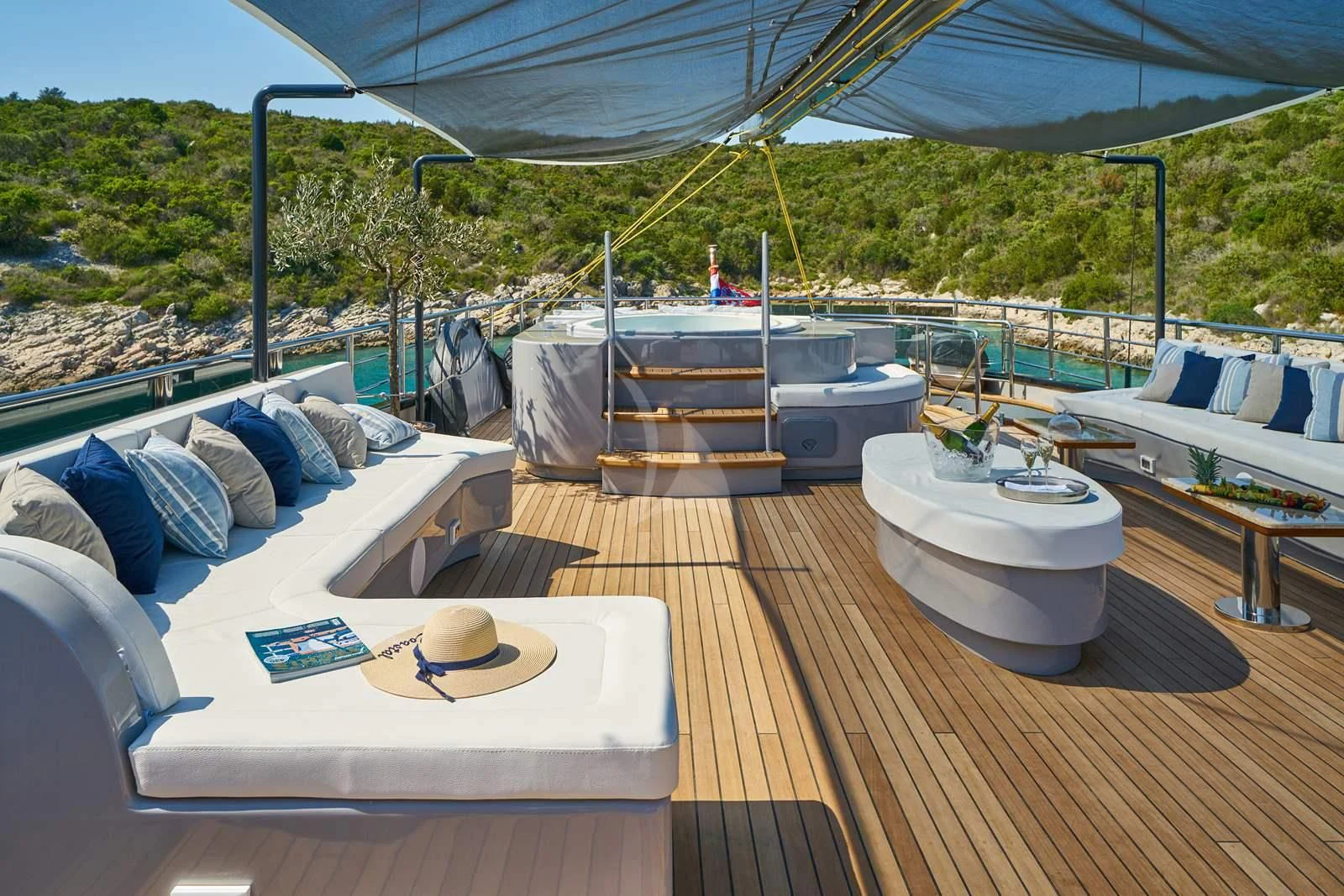a deck with a table and chairs on it aboard RARA AVIS Yacht for Charter