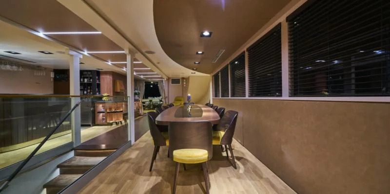 a room with a table and chairs aboard RARA AVIS Yacht for Charter