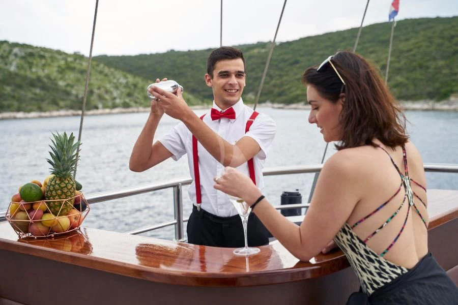a man and woman drinking wine on a boat aboard RARA AVIS Yacht for Charter