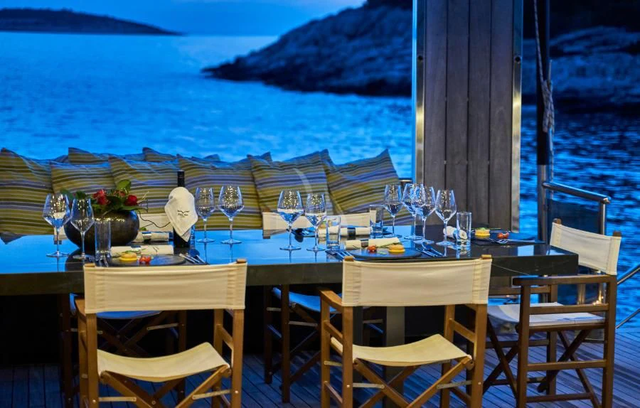 a table set for a dinner on a boat aboard RARA AVIS Yacht for Charter