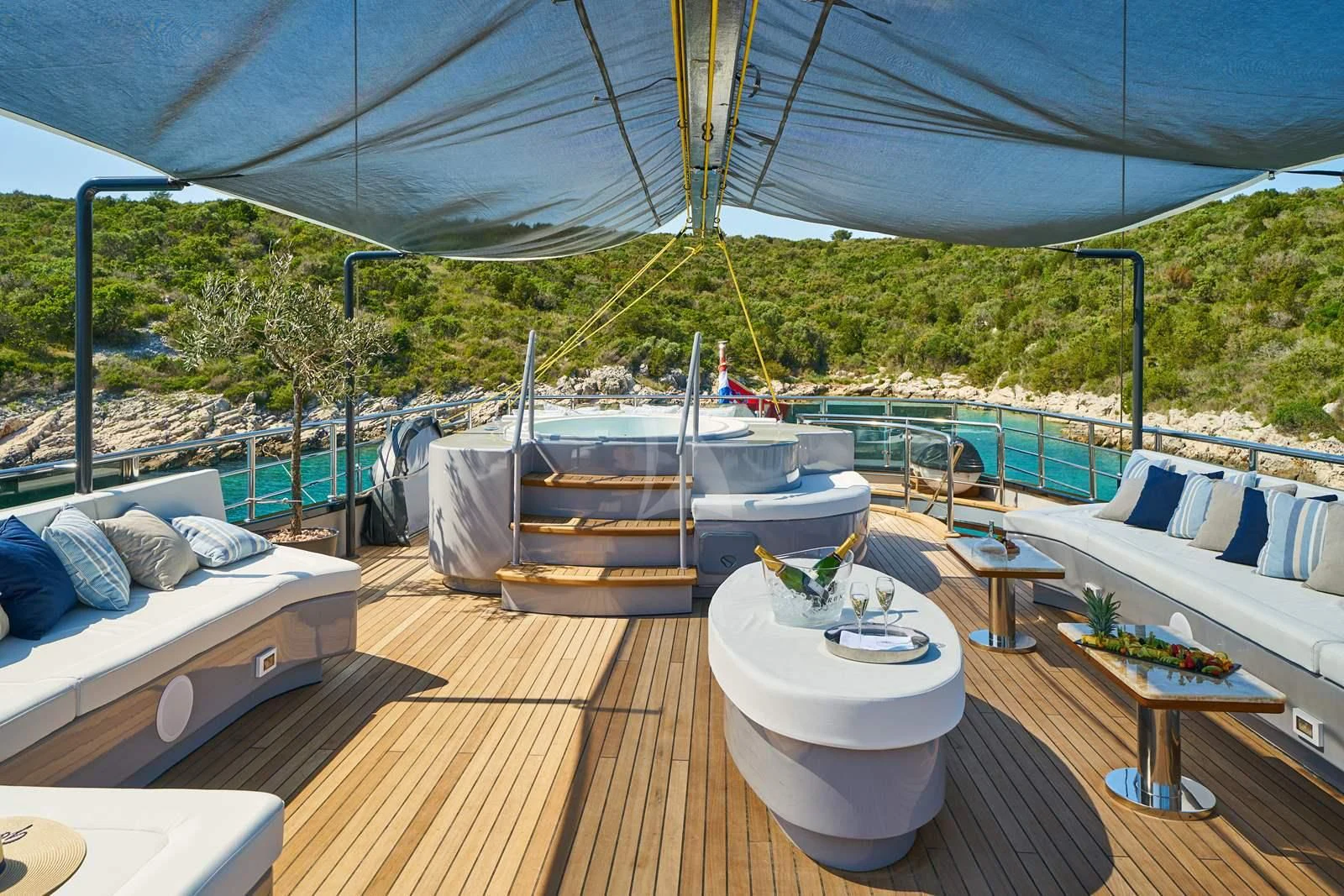 a deck with a large tent and a picnic table on it aboard RARA AVIS Yacht for Charter