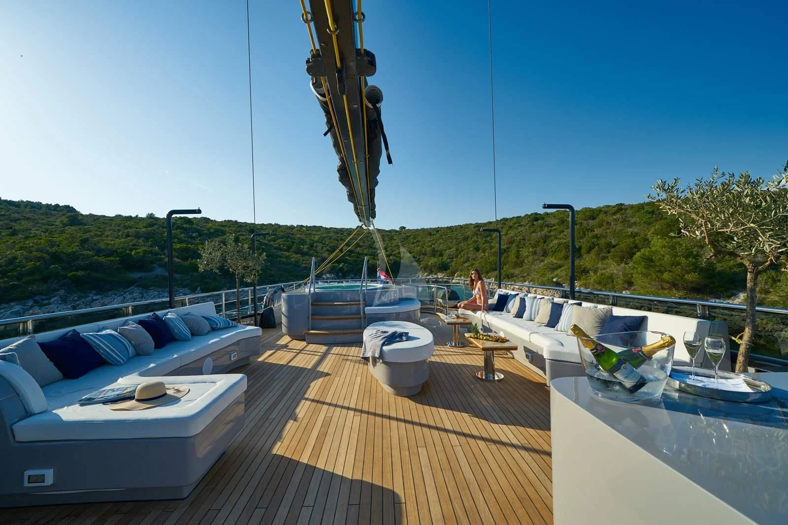 a deck with a pool and a couple people on it aboard RARA AVIS Yacht for Charter