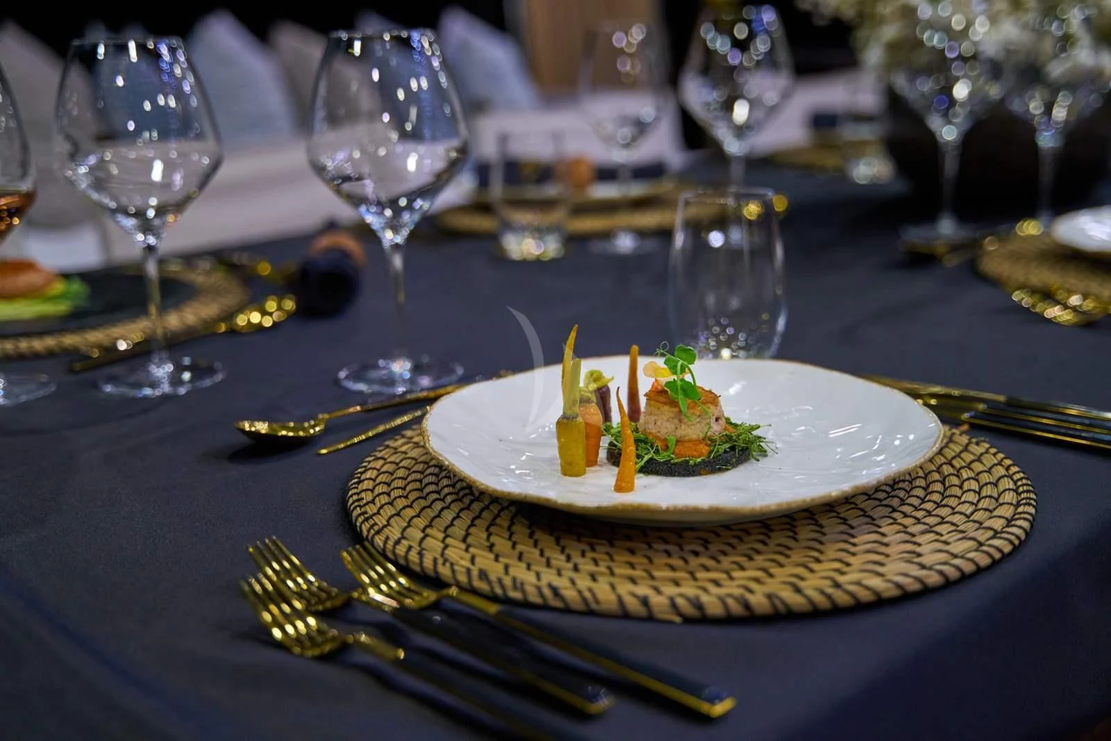 a plate of food and glasses aboard RARA AVIS Yacht for Charter