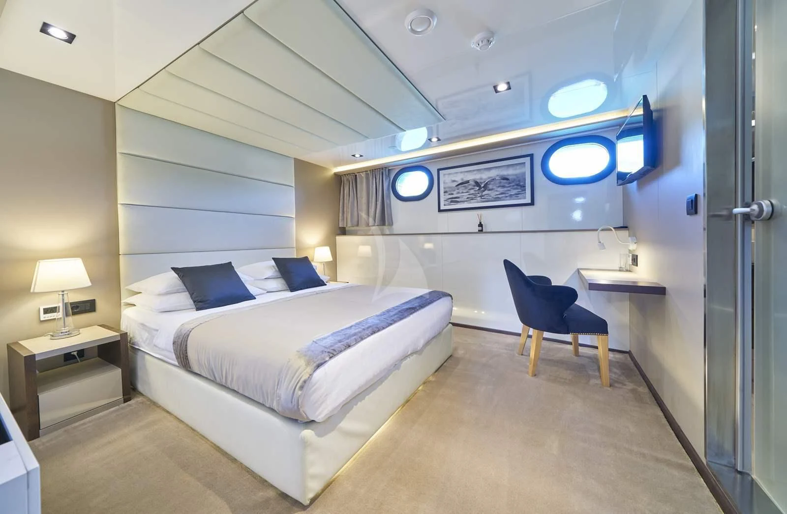 a room with a bed and a desk aboard RARA AVIS Yacht for Charter