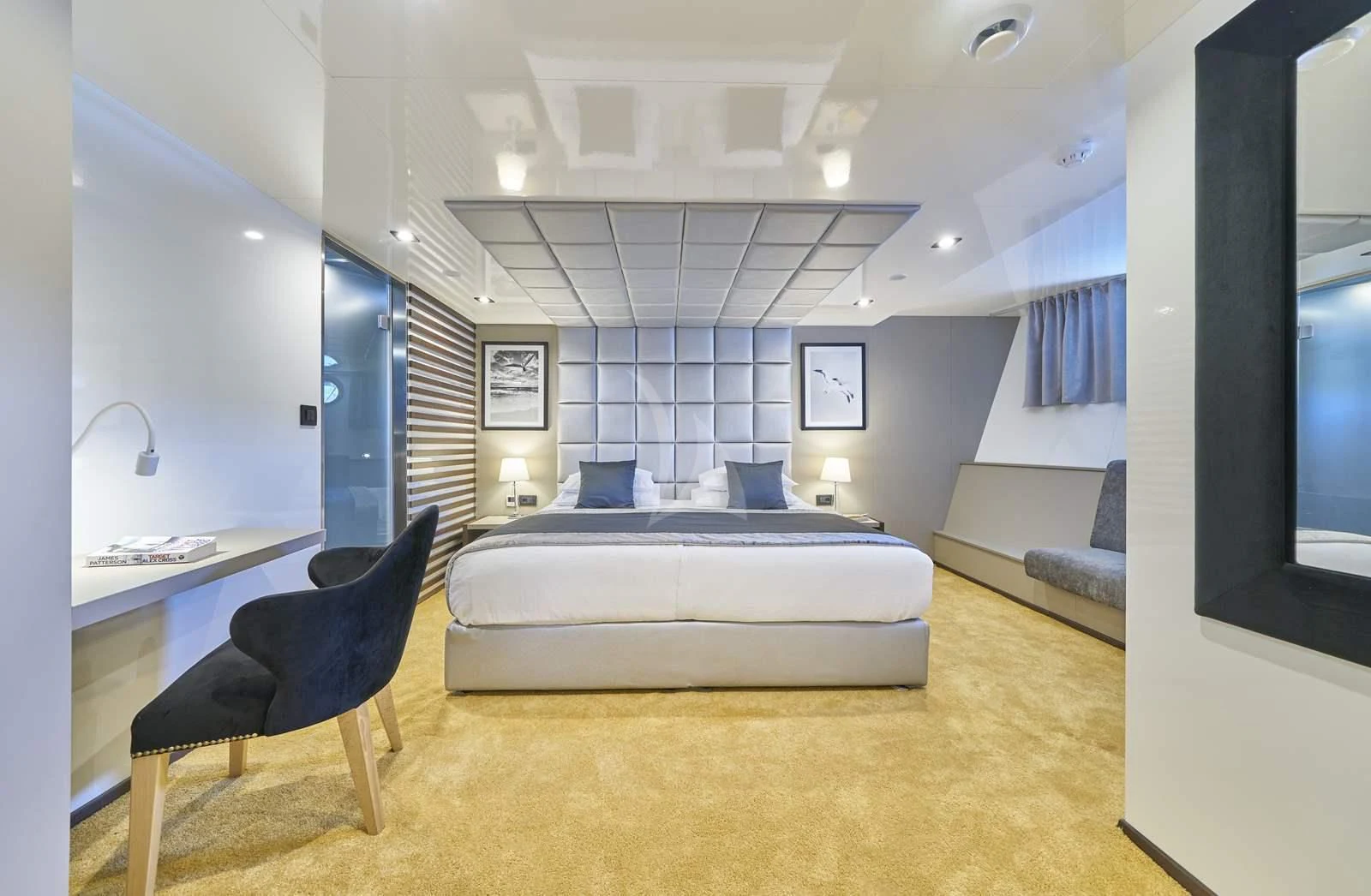 a room with a bed and a chair aboard RARA AVIS Yacht for Charter