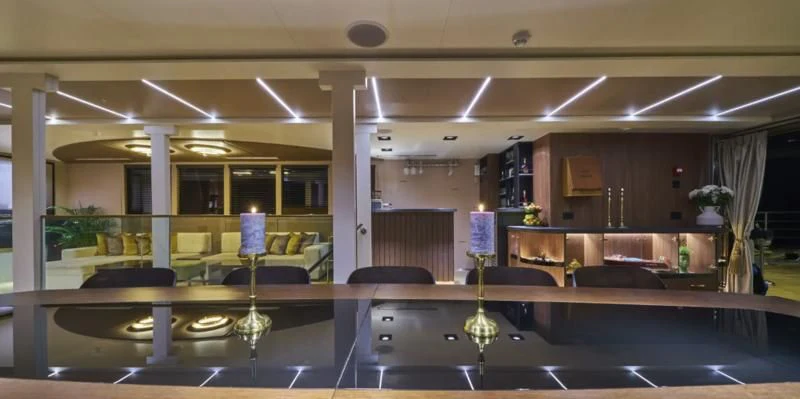 a room with a table and chairs aboard RARA AVIS Yacht for Charter