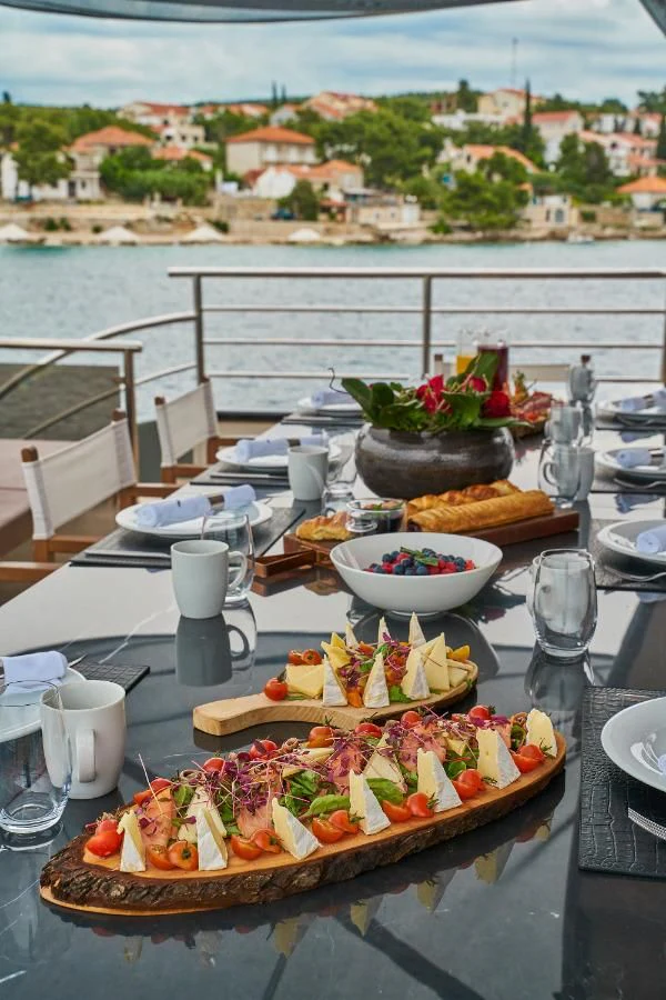 a table with food and drinks on it aboard RARA AVIS Yacht for Charter