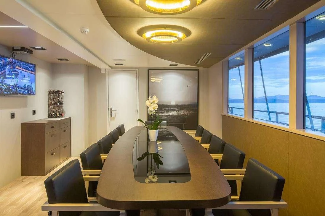 a room with a table and chairs aboard RARA AVIS Yacht for Charter