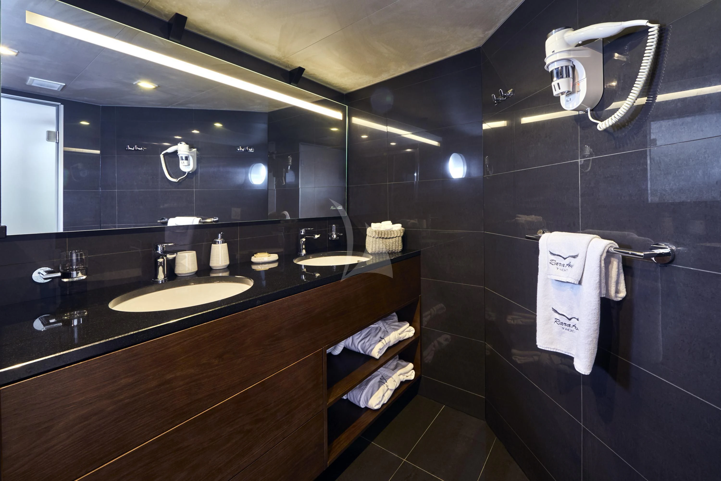 a bathroom with a large mirror aboard RARA AVIS Yacht for Charter