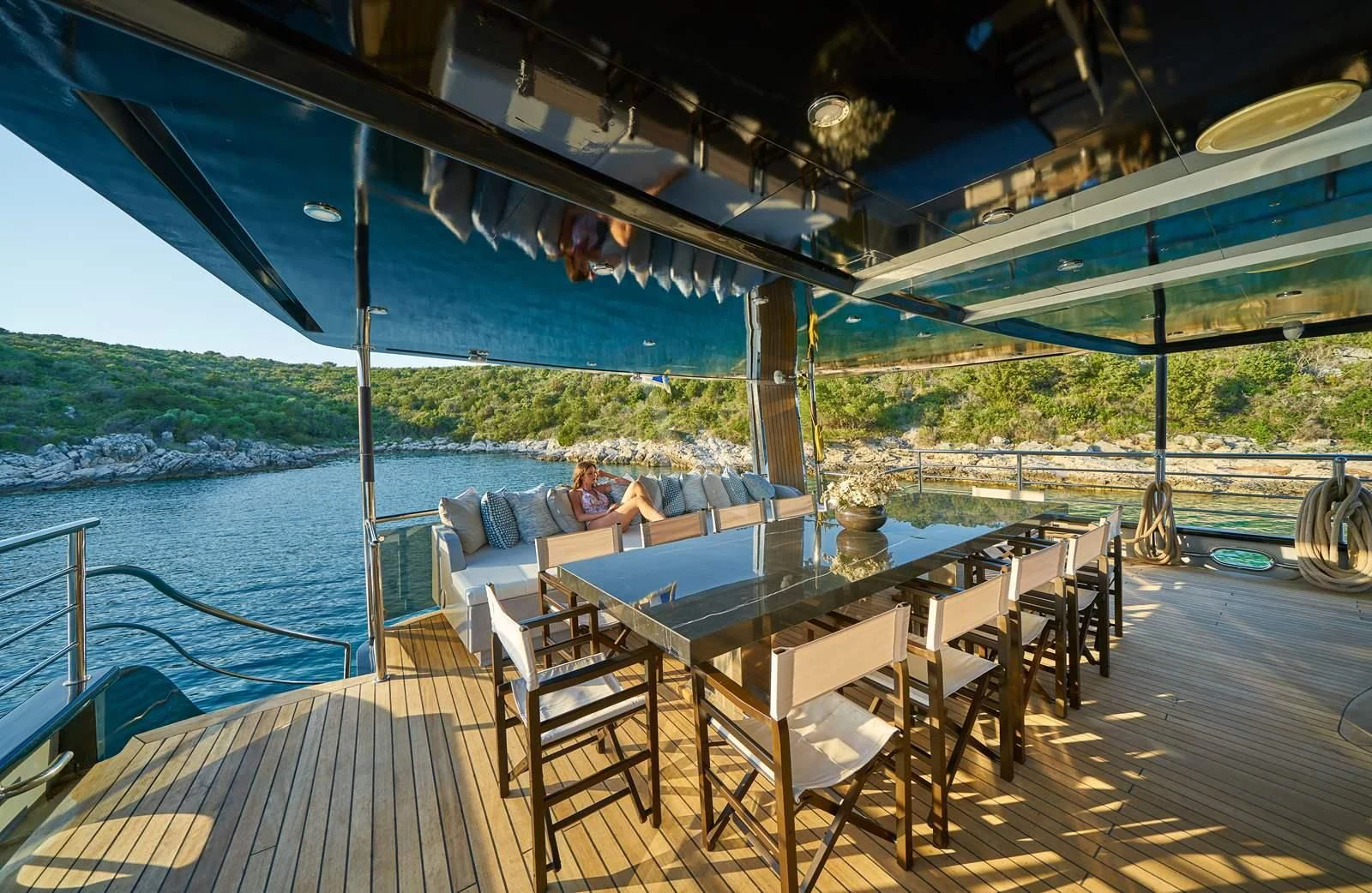 a deck with a table and chairs on it aboard RARA AVIS Yacht for Charter