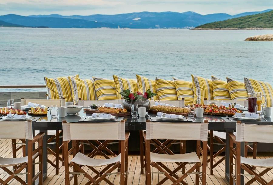 a table set for a meal on a boat aboard RARA AVIS Yacht for Charter