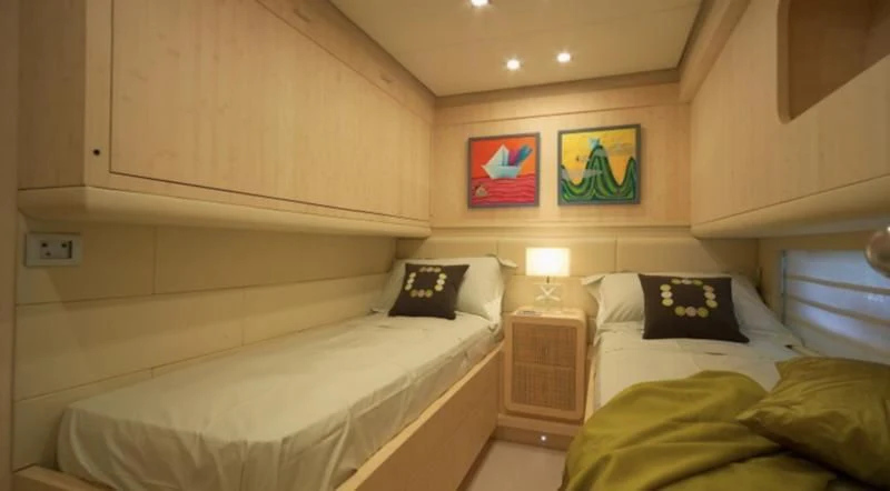 a room with two beds aboard EL DISPARO Yacht for Sale