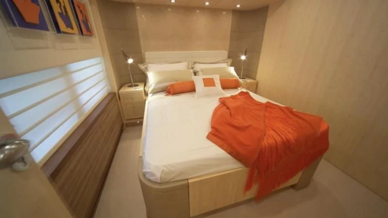 a room with a bed and a window aboard EL DISPARO Yacht for Sale