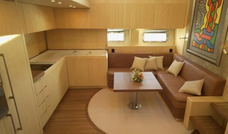 a living room with a couch and a table aboard EL DISPARO Yacht for Sale