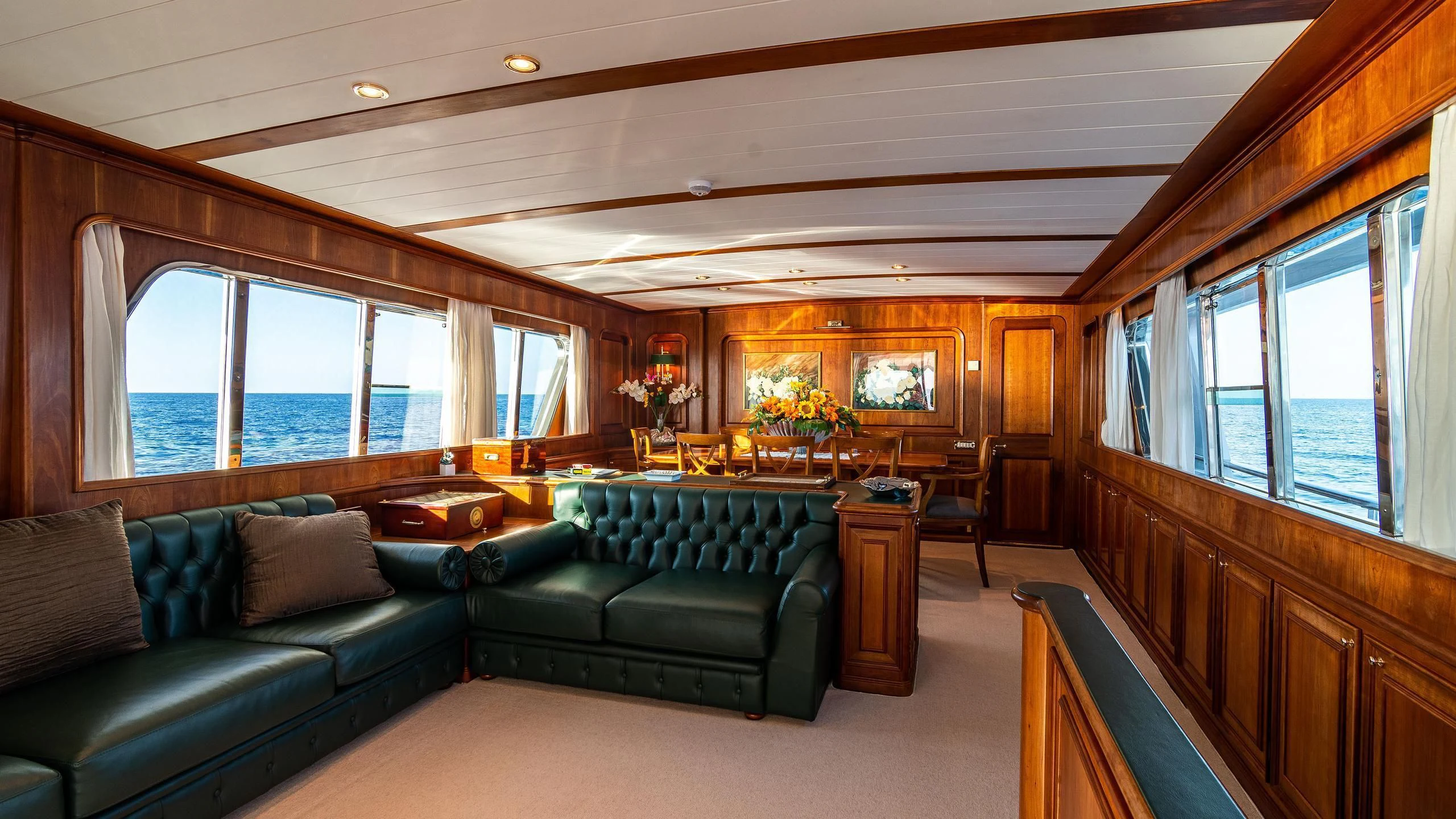 a living room with a couch and a large window aboard A&A Yacht for Charter