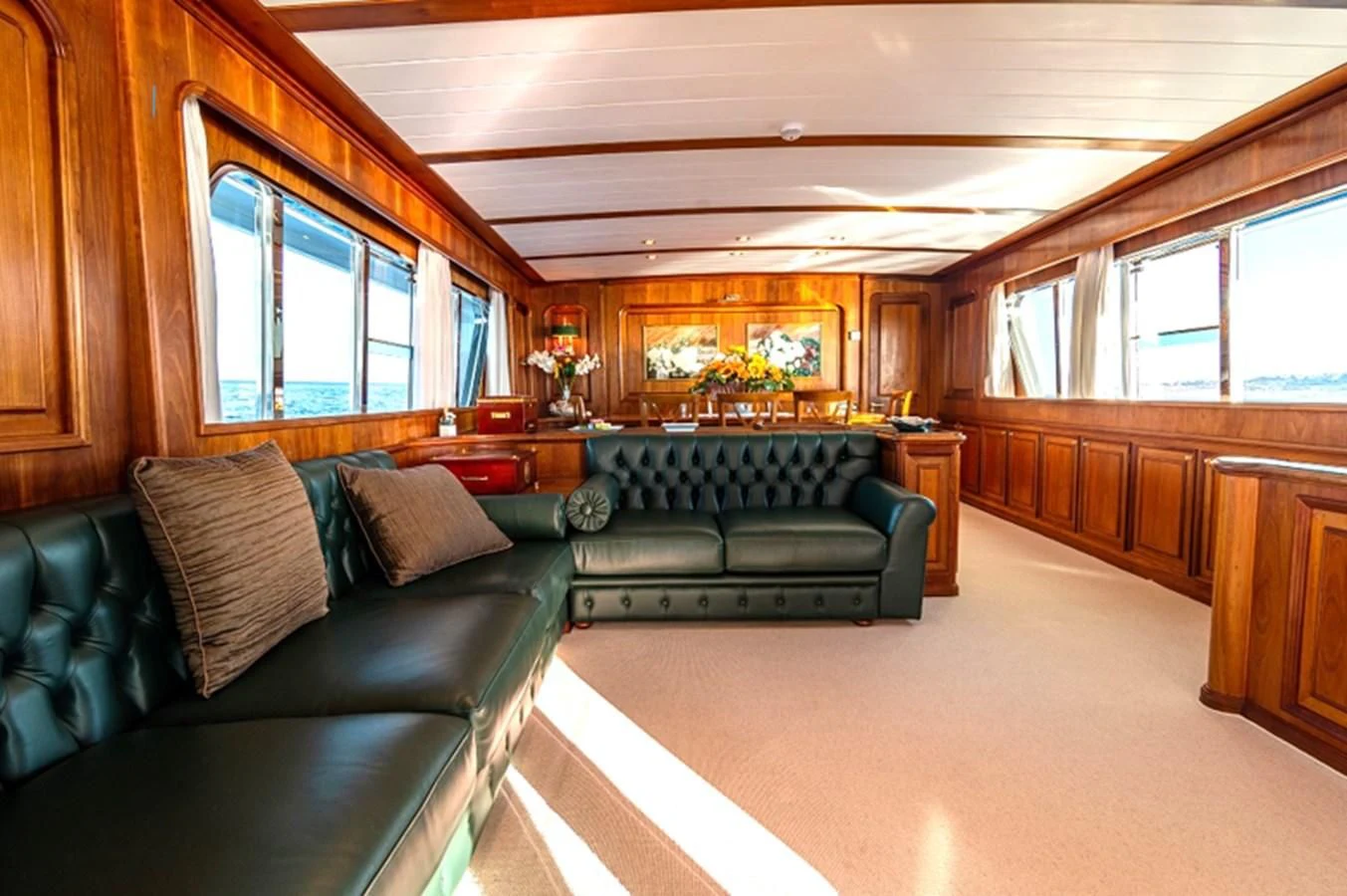a living room with leather couches aboard A&A Yacht for Charter