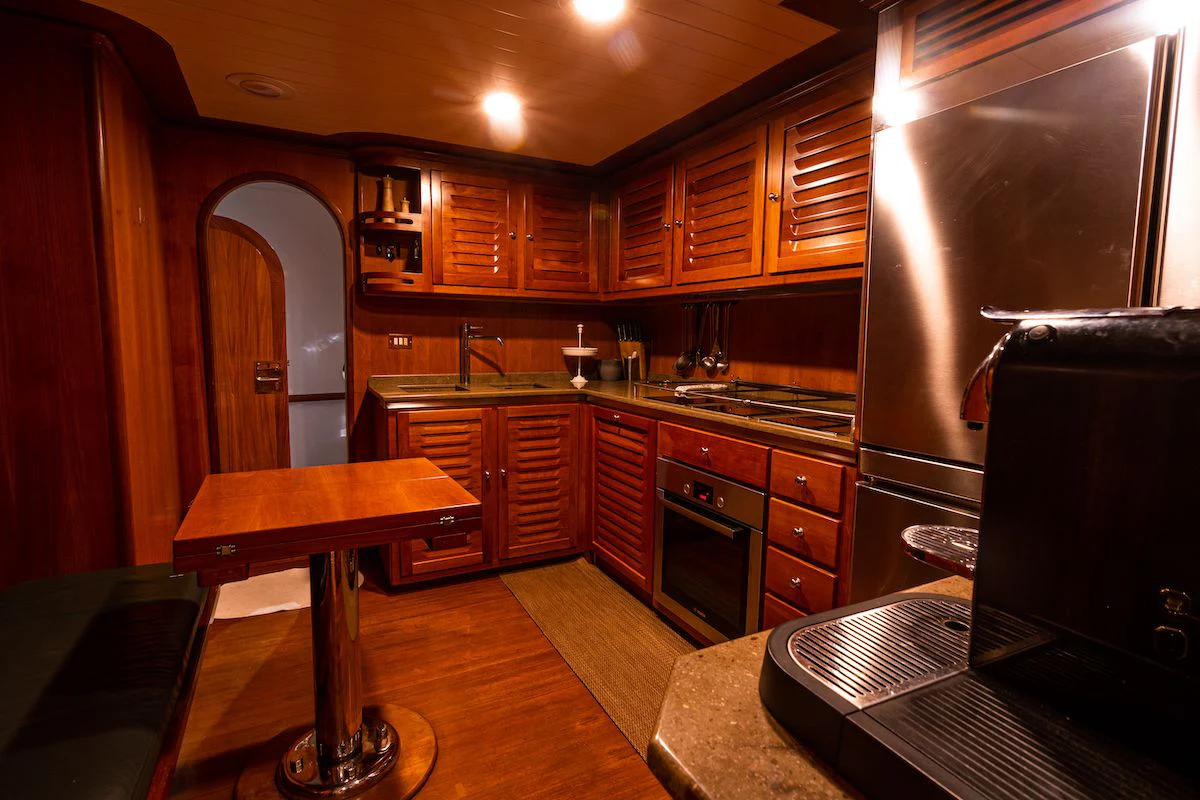 a kitchen with wooden cabinets aboard A&A Yacht for Charter