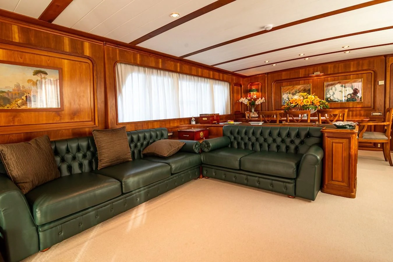 a living room with a green couch aboard A&A Yacht for Charter