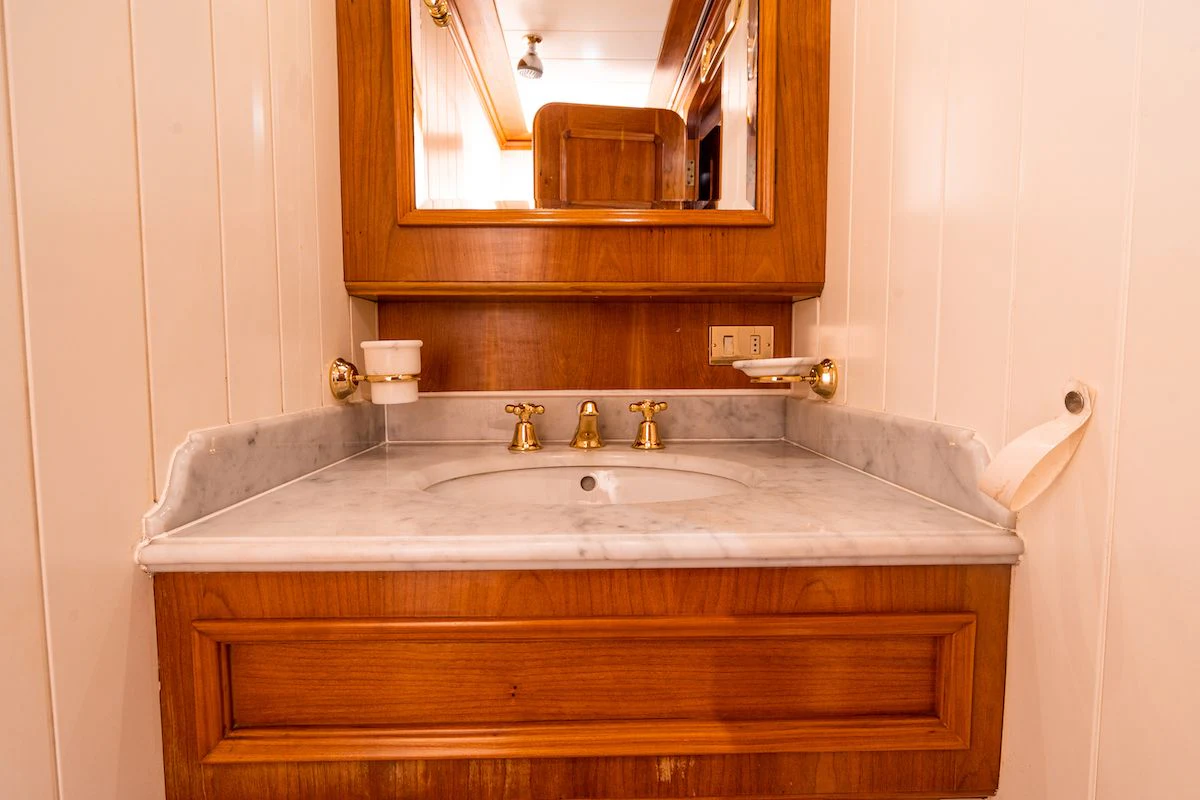 a bathroom with a sink and a mirror aboard A&A Yacht for Charter