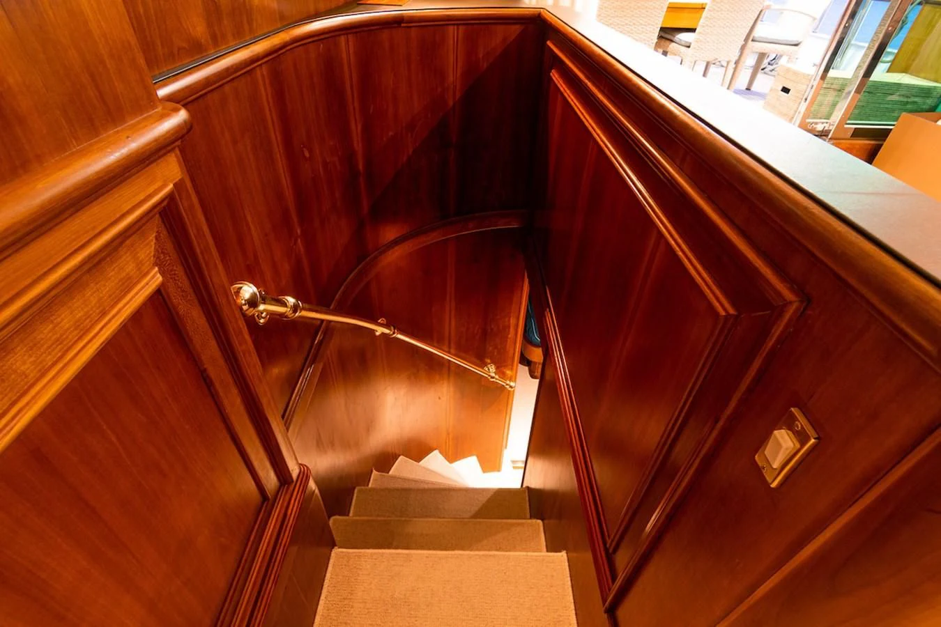 a wooden staircase with a metal railing aboard A&A Yacht for Charter