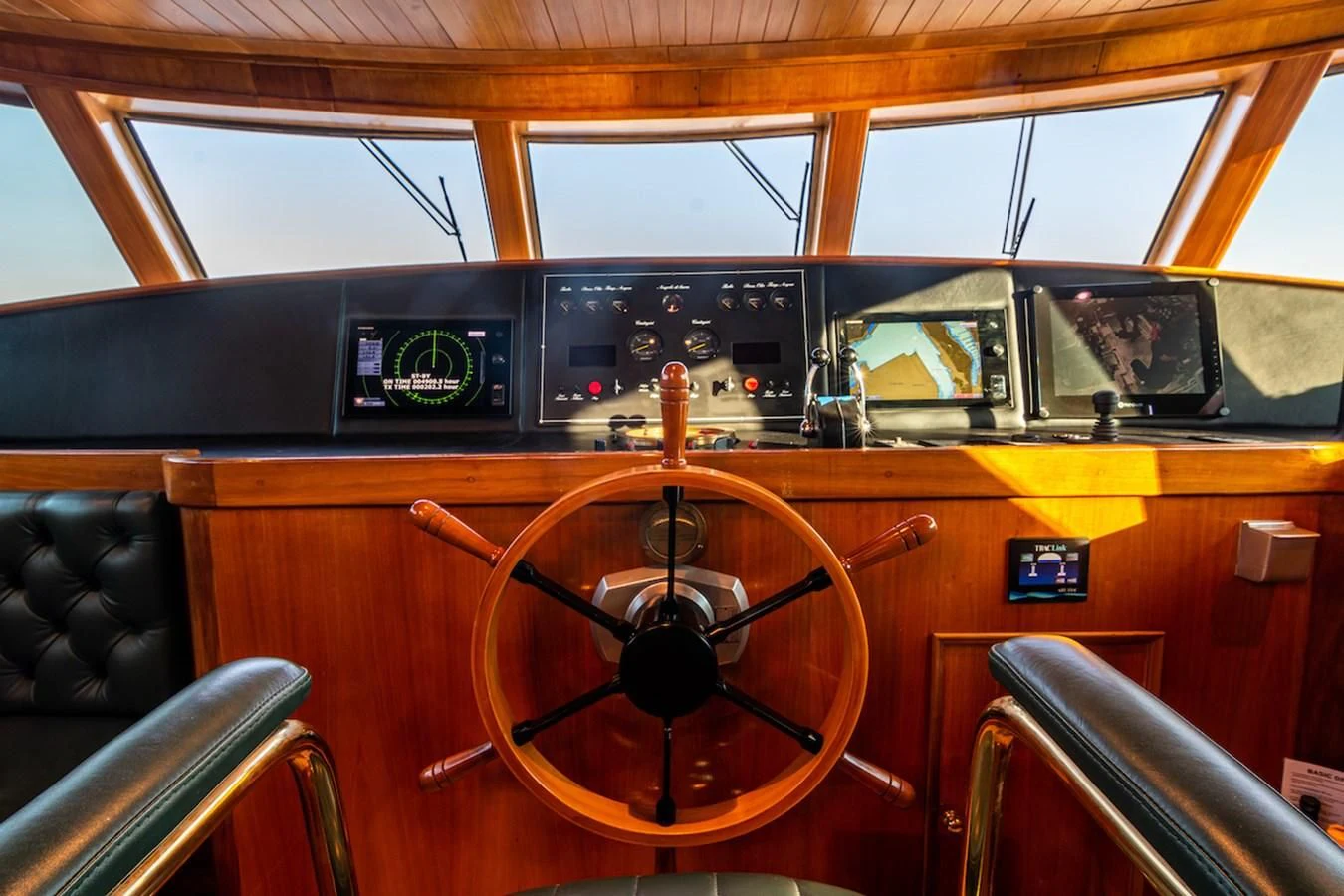 a wooden boat with a steering wheel aboard A&A Yacht for Charter