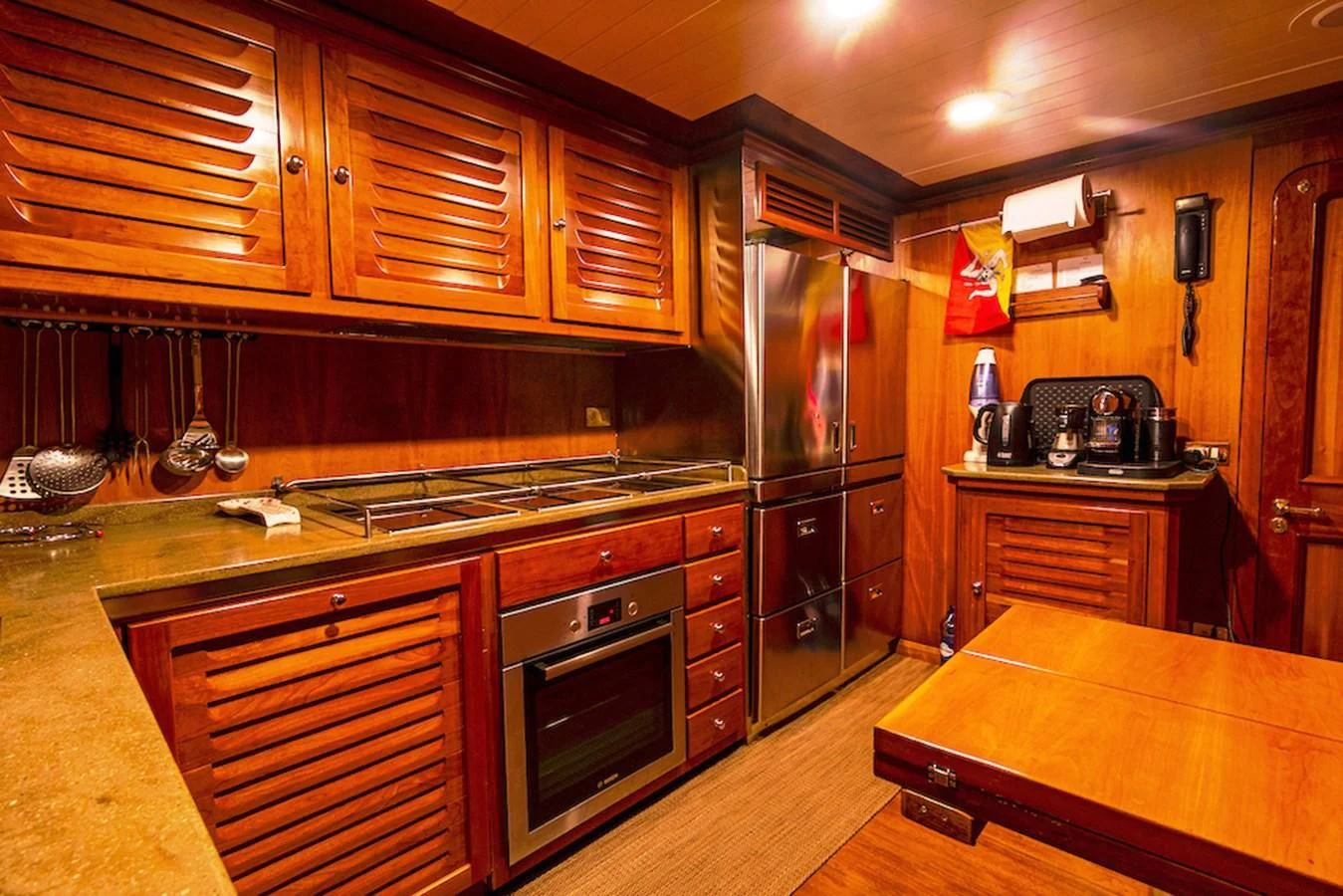 a kitchen with wooden cabinets aboard A&A Yacht for Charter