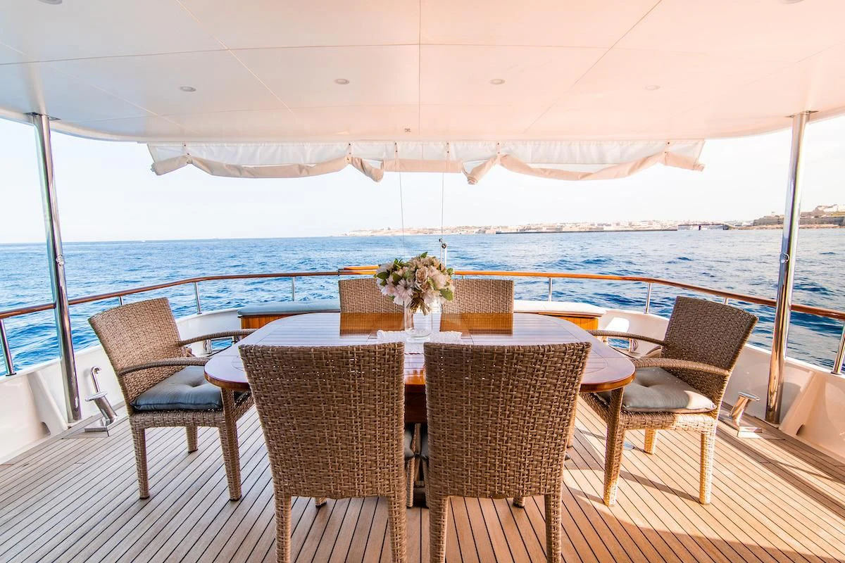 a table and chairs on a patio aboard A&A Yacht for Charter