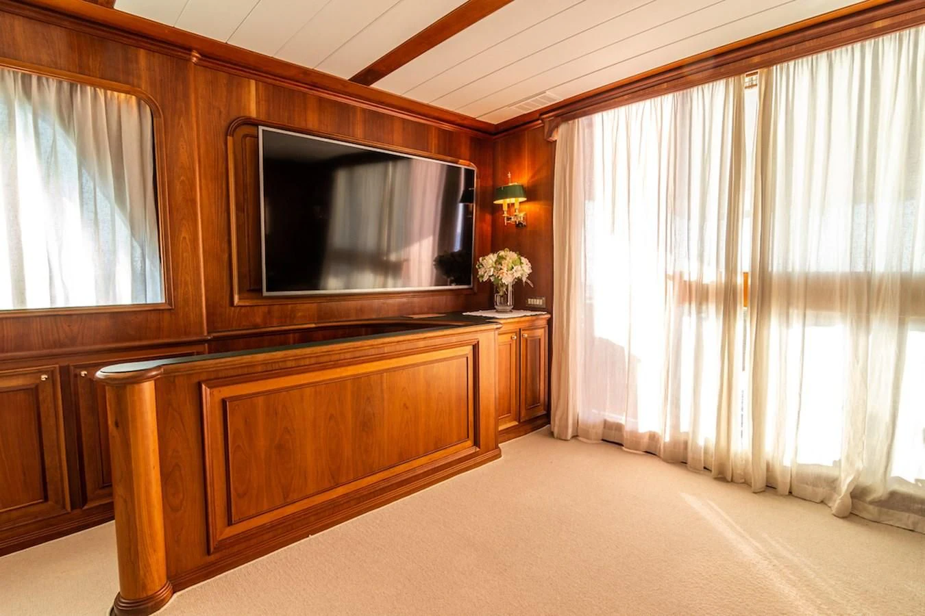 a room with a television and a curtain aboard A&A Yacht for Charter