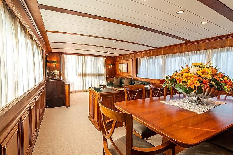a large room with a table and chairs aboard A&A Yacht for Charter