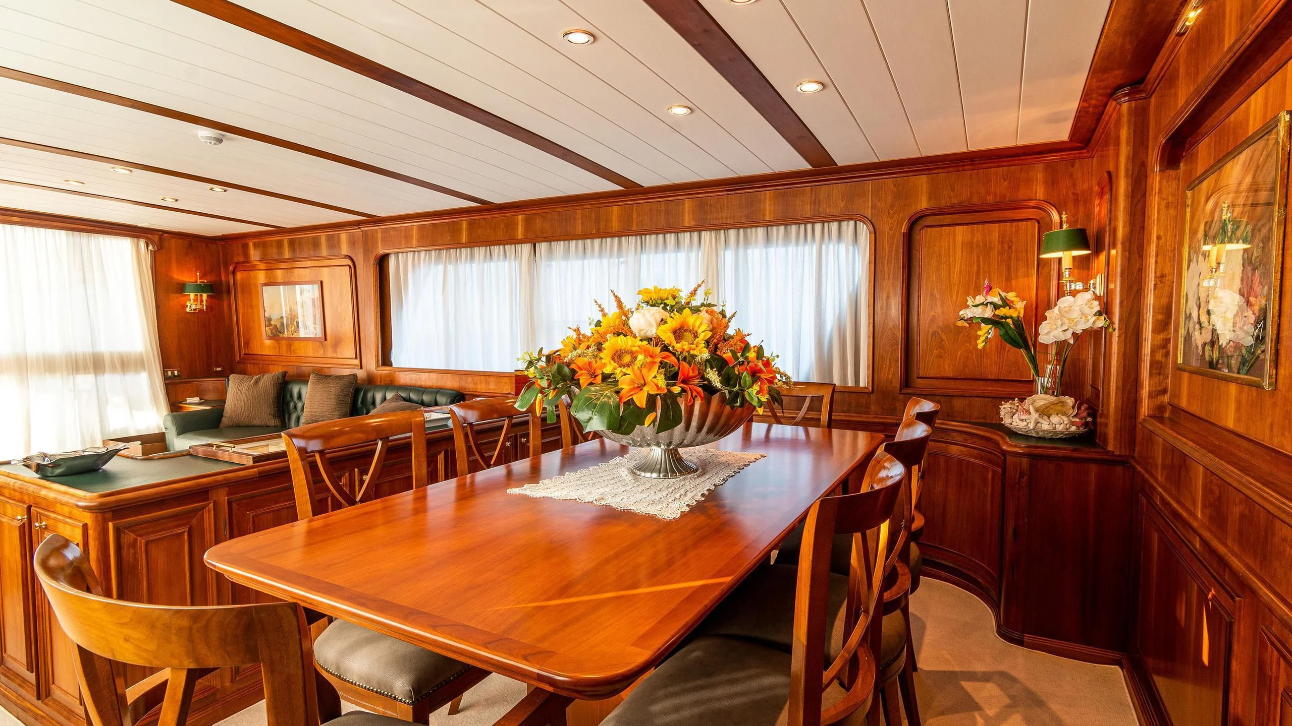a dining room with a table and chairs aboard A&A Yacht for Charter