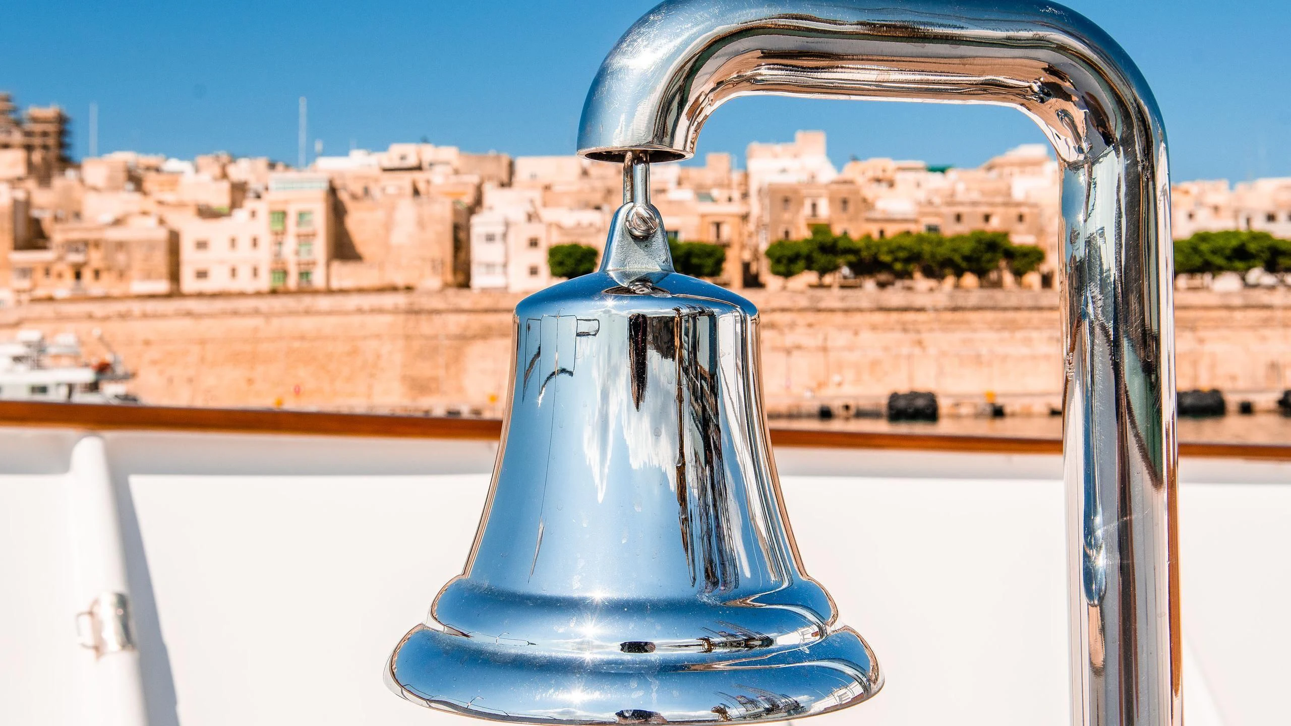 a water fountain with a city in the background aboard A&A Yacht for Charter
