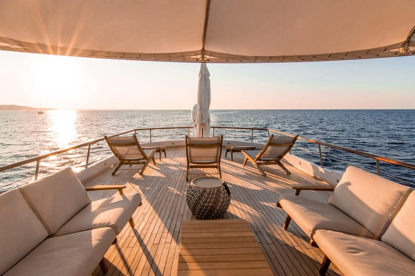 a deck with chairs and a large body of water aboard A&A Yacht for Charter